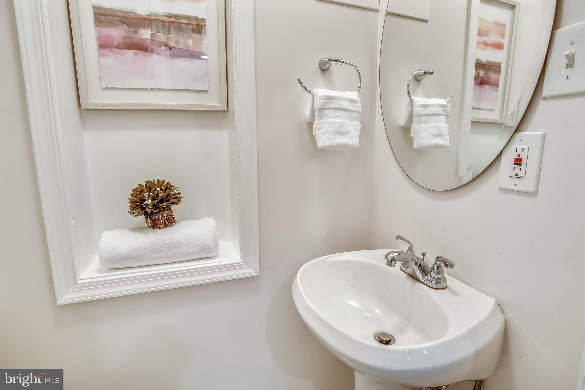 9051 Manchester Road Silver Spring, MD 20901 - Photo 11 of 37 a bathroom with a sink and mirror