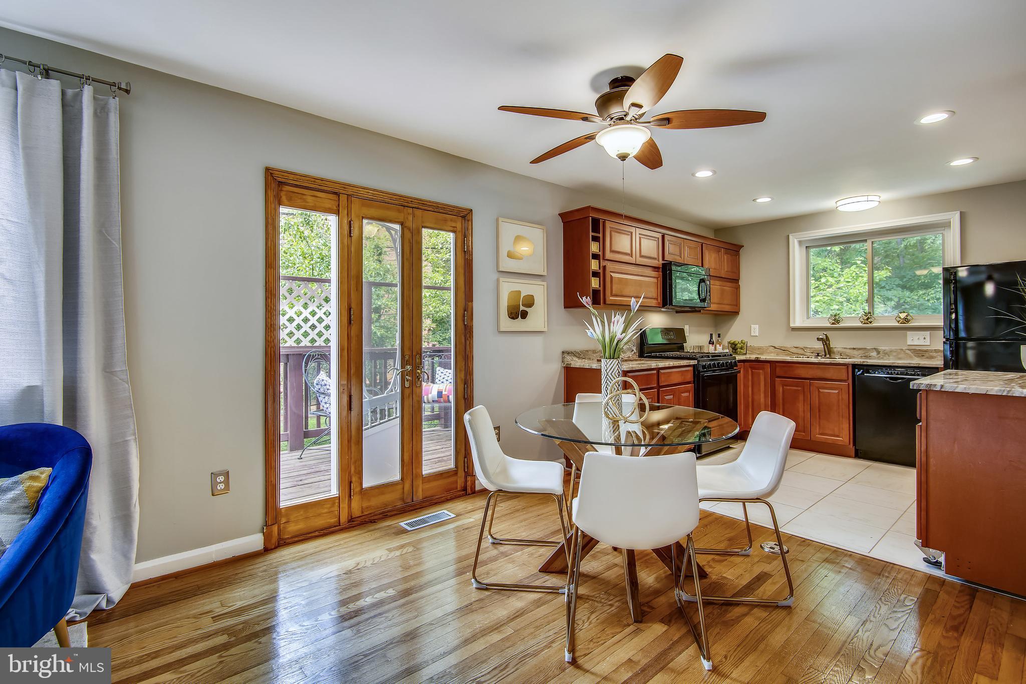 9051 Manchester Road Silver Spring, MD 20901 - Photo 13 of 37 a view of a dining room with furniture window and wooden floor
