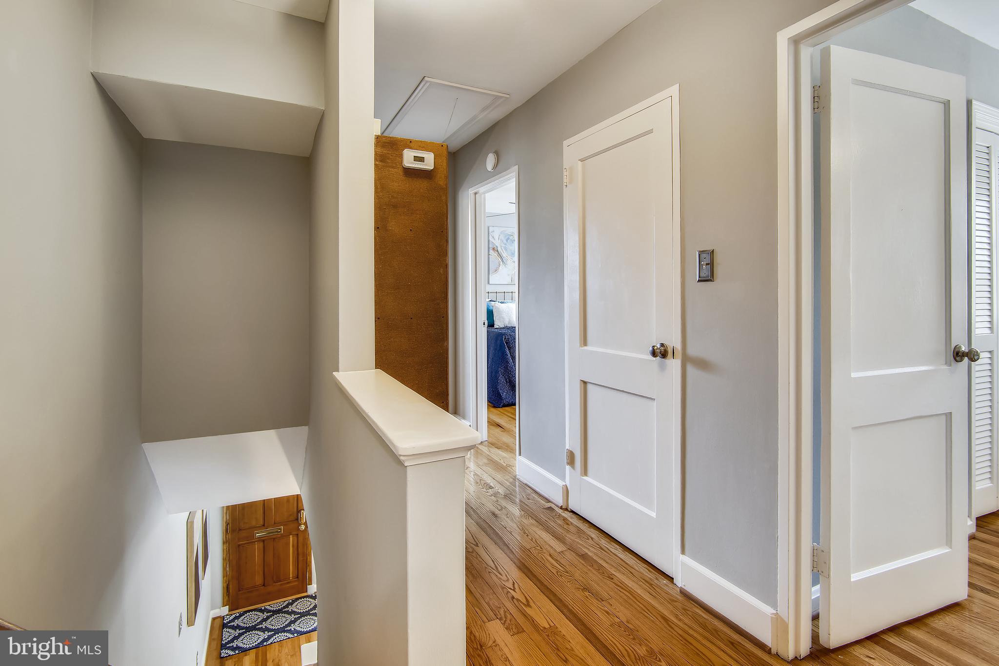 9051 Manchester Road Silver Spring, MD 20901 - Photo 17 of 37 a view of a hallway with bathroom and wooden floor
