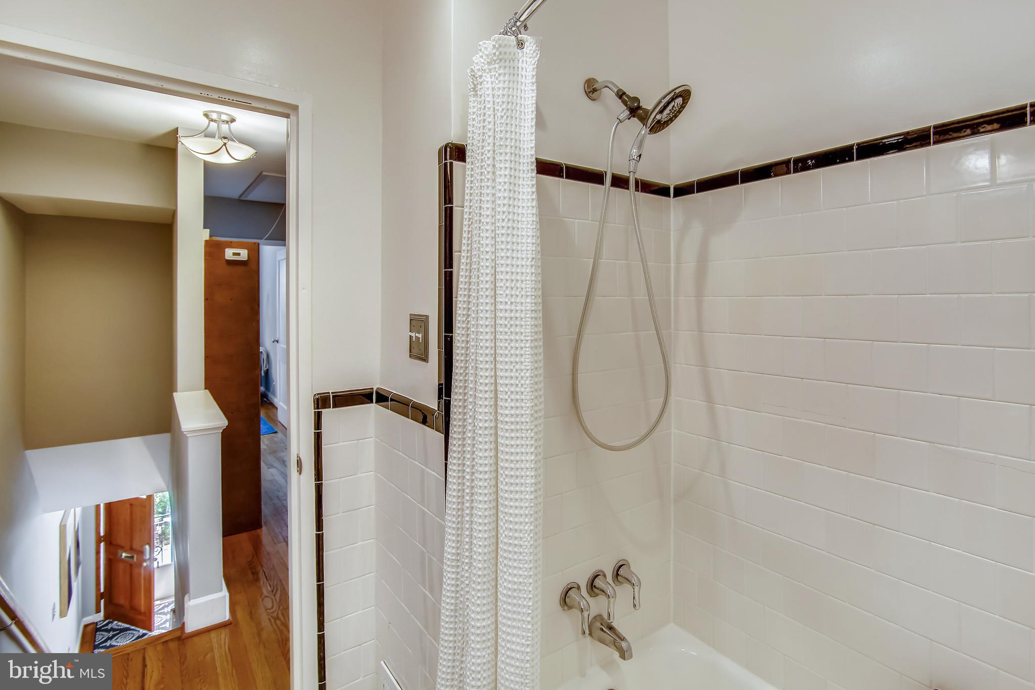 9051 Manchester Road Silver Spring, MD 20901 - Photo 21 of 37 a bathroom with a glass shower door