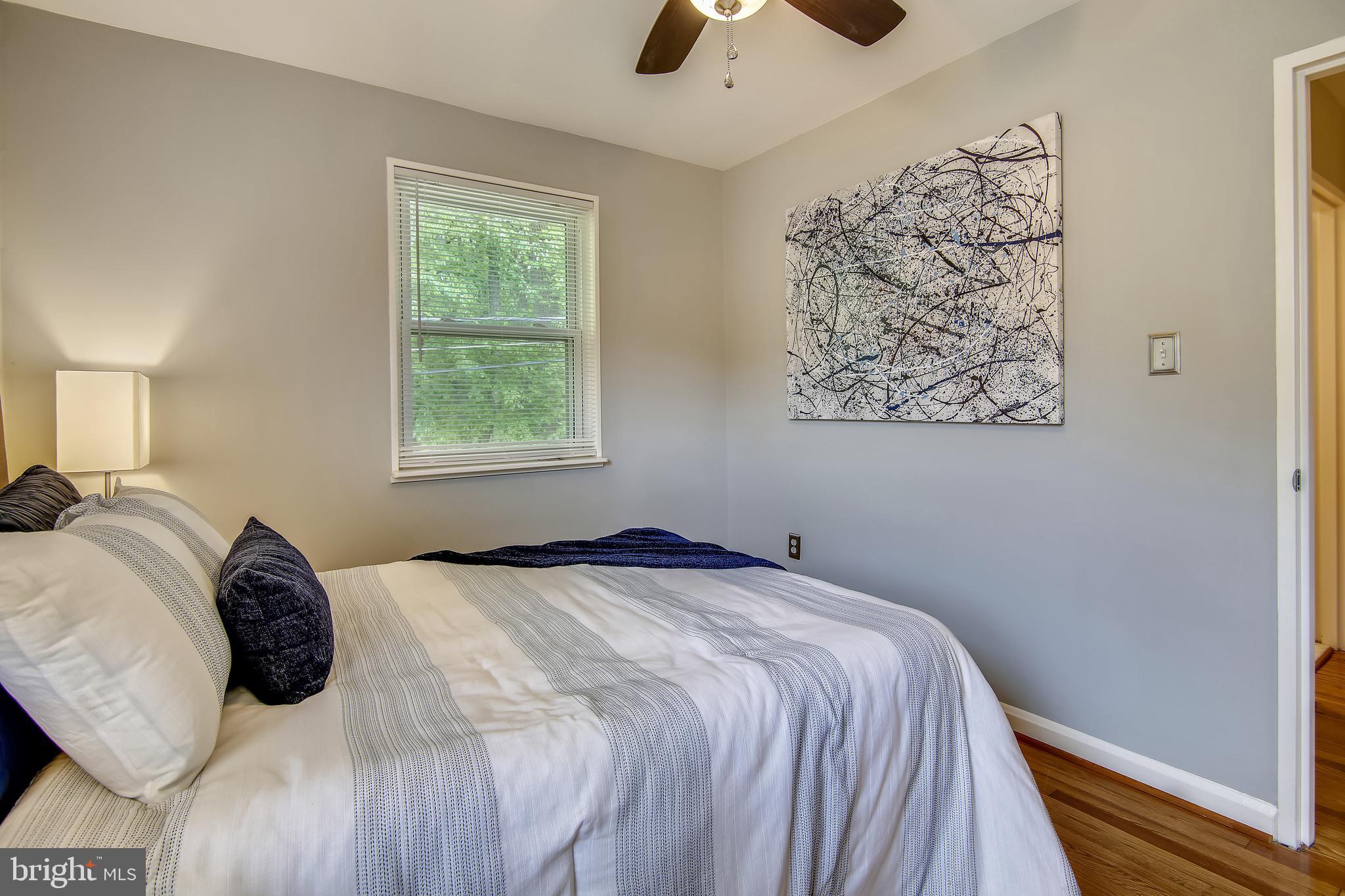 9051 Manchester Road Silver Spring, MD 20901 - Photo 23 of 37 a bedroom with a bed and a window