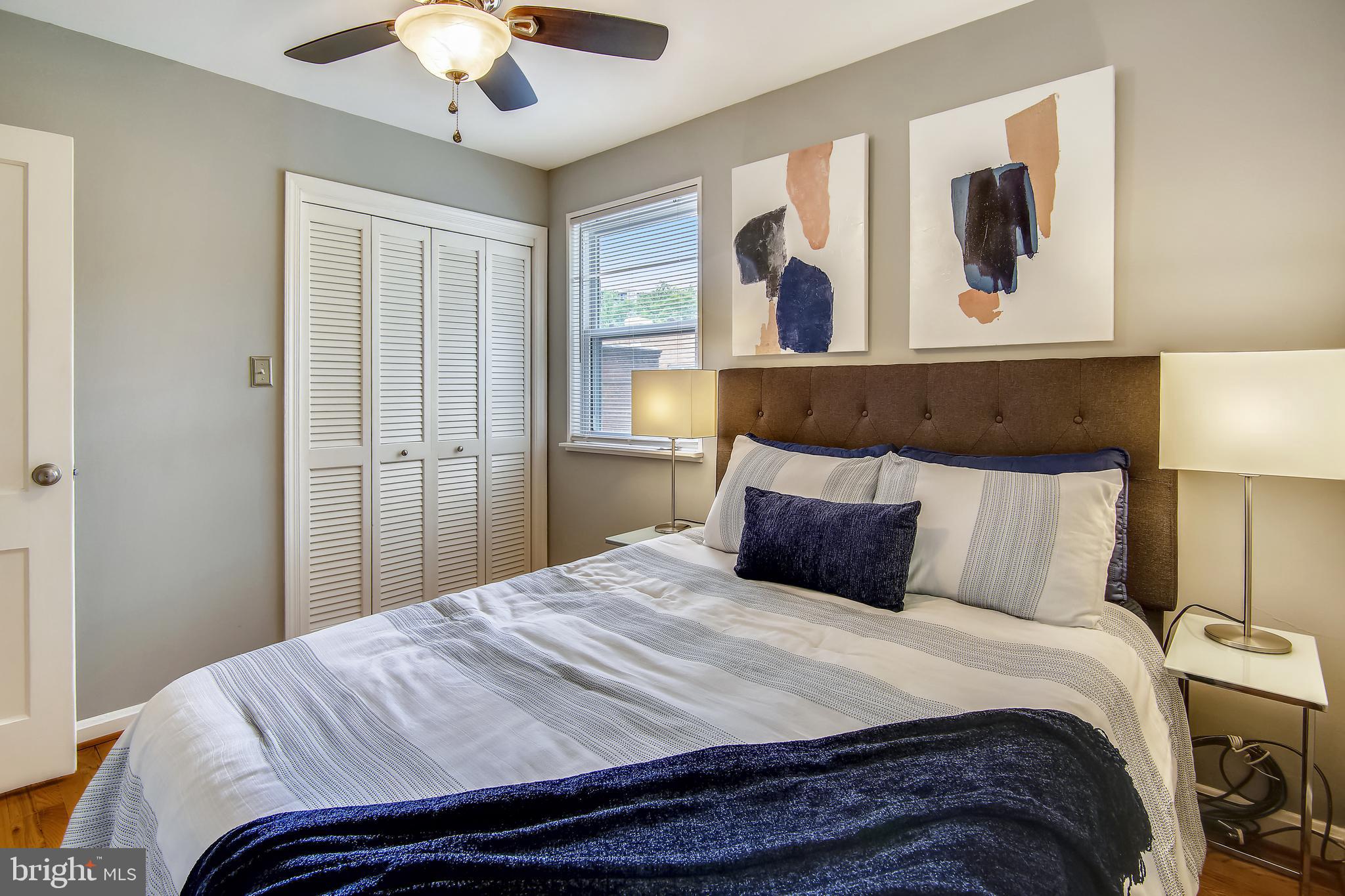 9051 Manchester Road Silver Spring, MD 20901 - Photo 24 of 37 a bedroom with a large bed and a chandelier