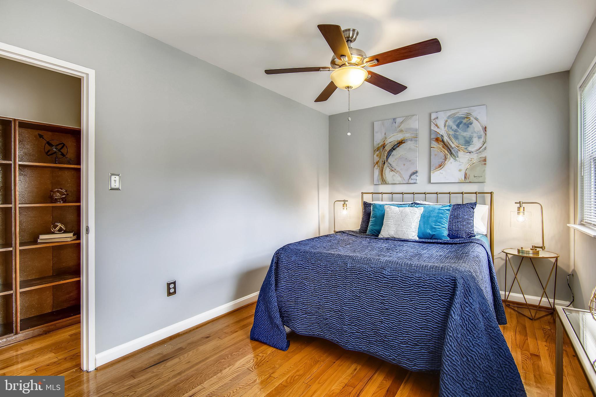 9051 Manchester Road Silver Spring, MD 20901 - Photo 28 of 37 a bedroom with a bed and a ceiling fan