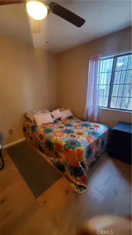 a bedroom with a bed and window