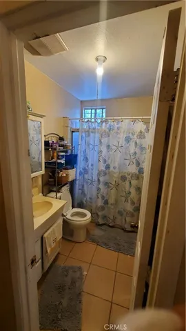 a bathroom with a toilet a sink and shower