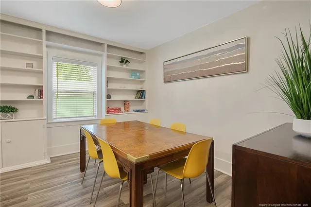 a view of a dining room with furniture and a potted plant