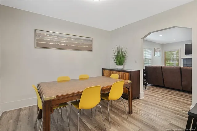 a view of a dining room with furniture and wooden floor