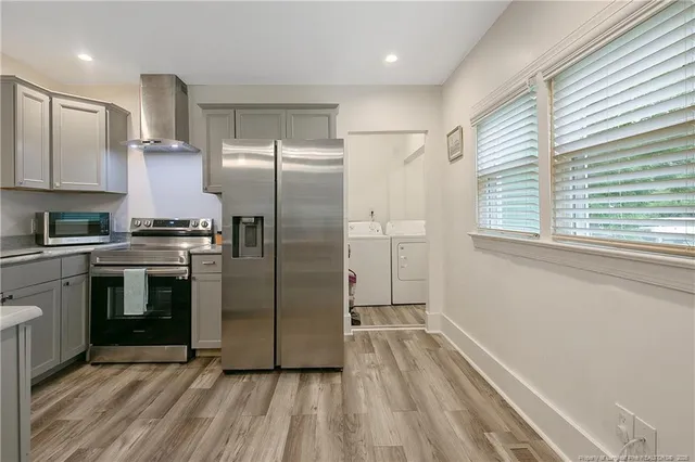 a kitchen with granite countertop a refrigerator and a stove
