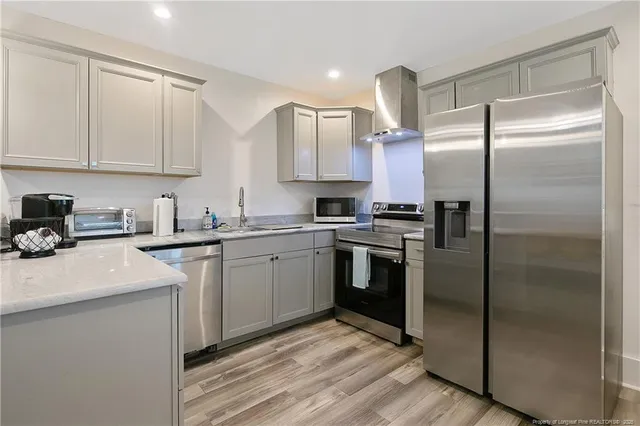 a kitchen with a refrigerator sink and cabinets