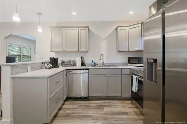 a kitchen with cabinets stainless steel appliances and a counter top space
