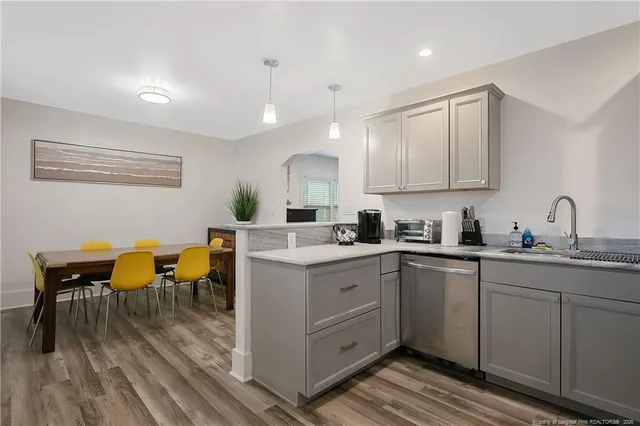 a kitchen with sink cabinets and dining table