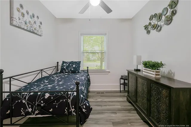 a bed sitting in a bedroom next to a window