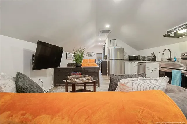 a living room with furniture and flat screen tv