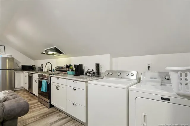 a view of kitchen with sink and refrigerator