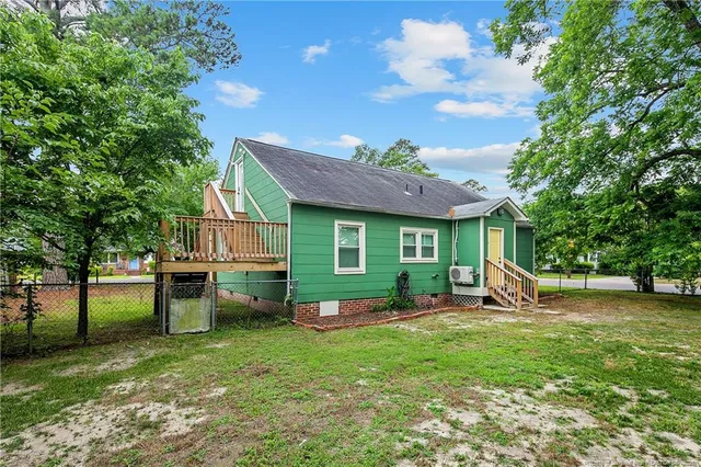 a view of a house with a backyard and a patio