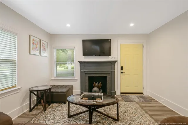 a living room with furniture and a fireplace