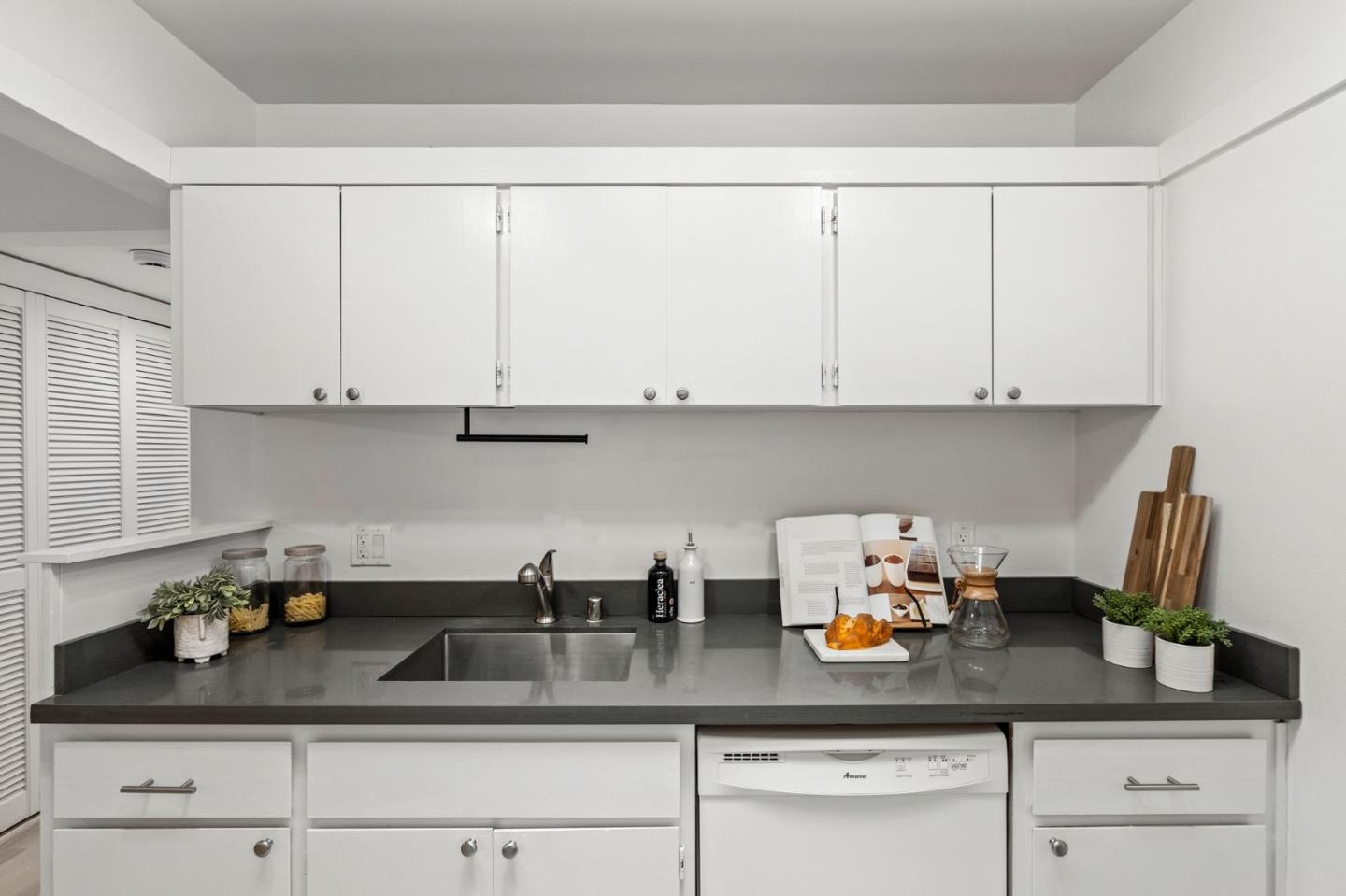 500 West Middlefield Road, Unit 101 Mountain View, CA 94043 - Photo 15 of 37 a kitchen with white cabinets a sink and potted plant