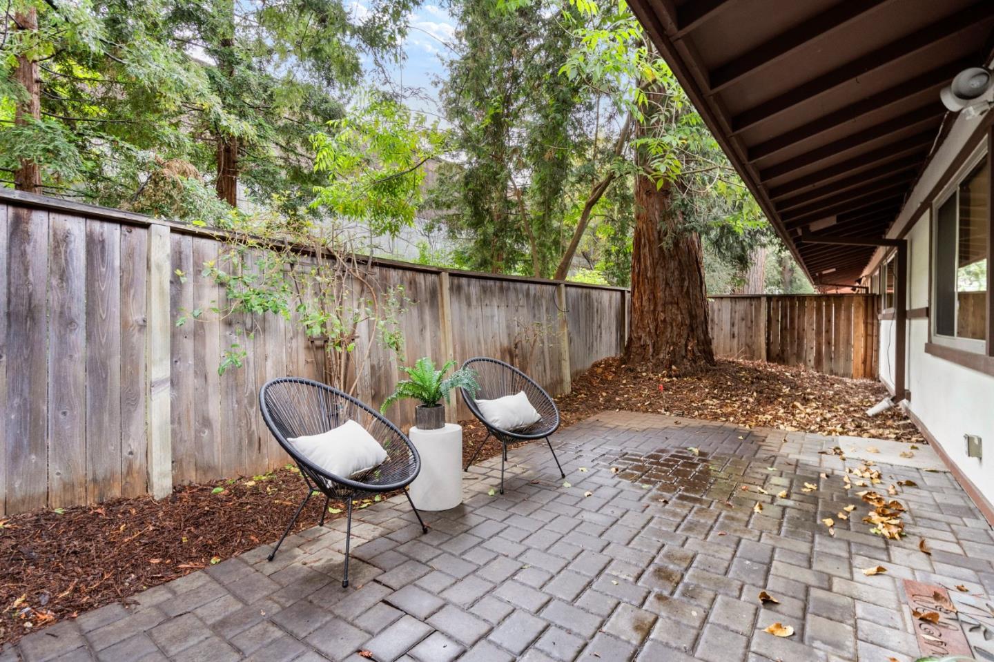 500 West Middlefield Road, Unit 101 Mountain View, CA 94043 - Photo 26 of 37 a view of a backyard with table and chairs with wooden fence