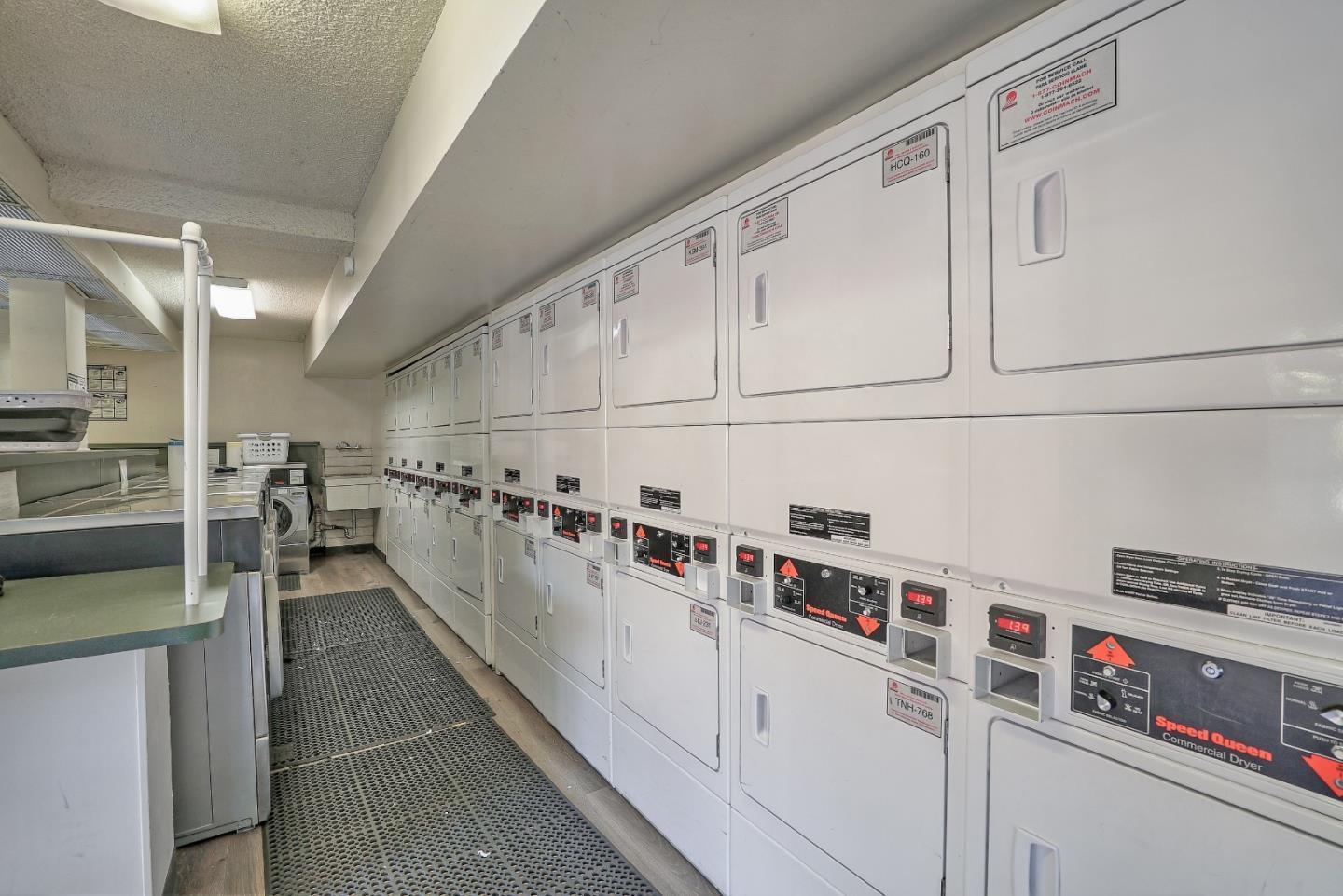 500 West Middlefield Road, Unit 101 Mountain View, CA 94043 - Photo 37 of 37 a hallway with white cabinets and white appliances