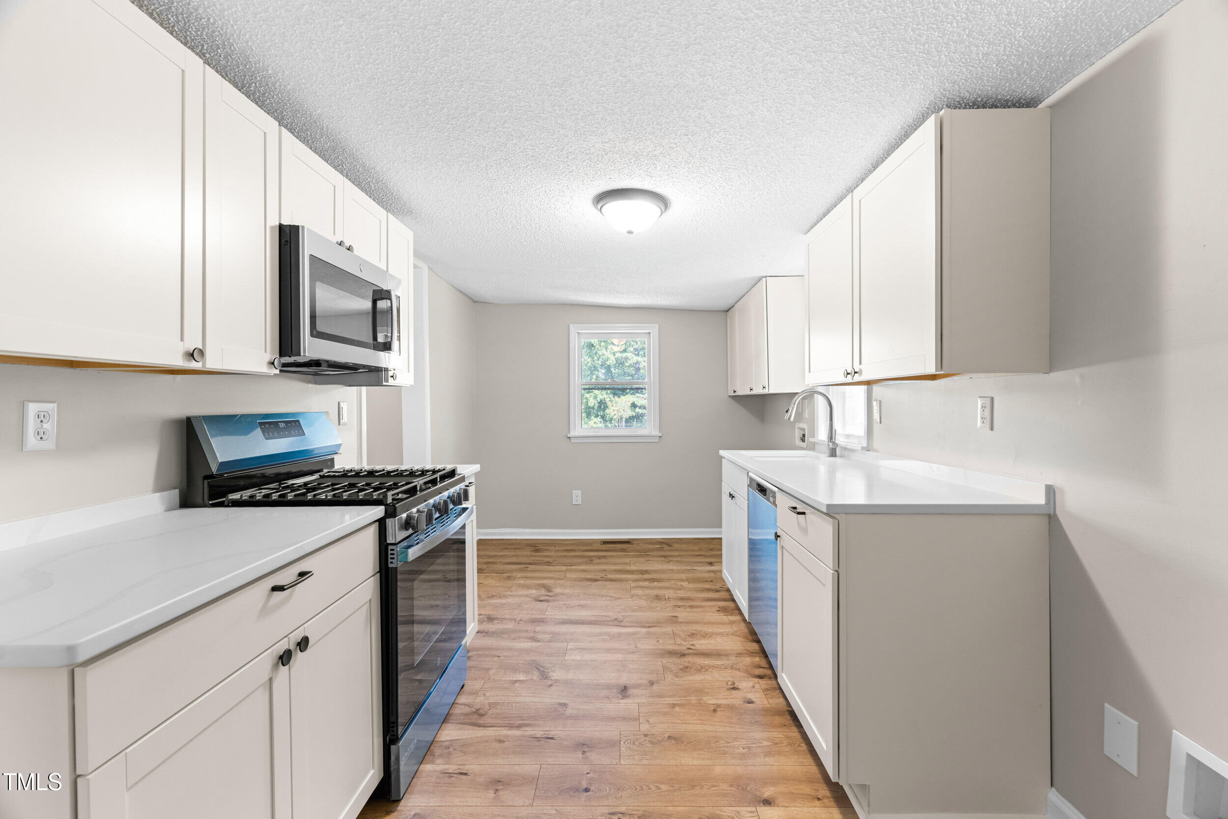612 North 4th Street Smithfield, NC 27577 - Photo 12 of 22 a kitchen with a sink stove and cabinets