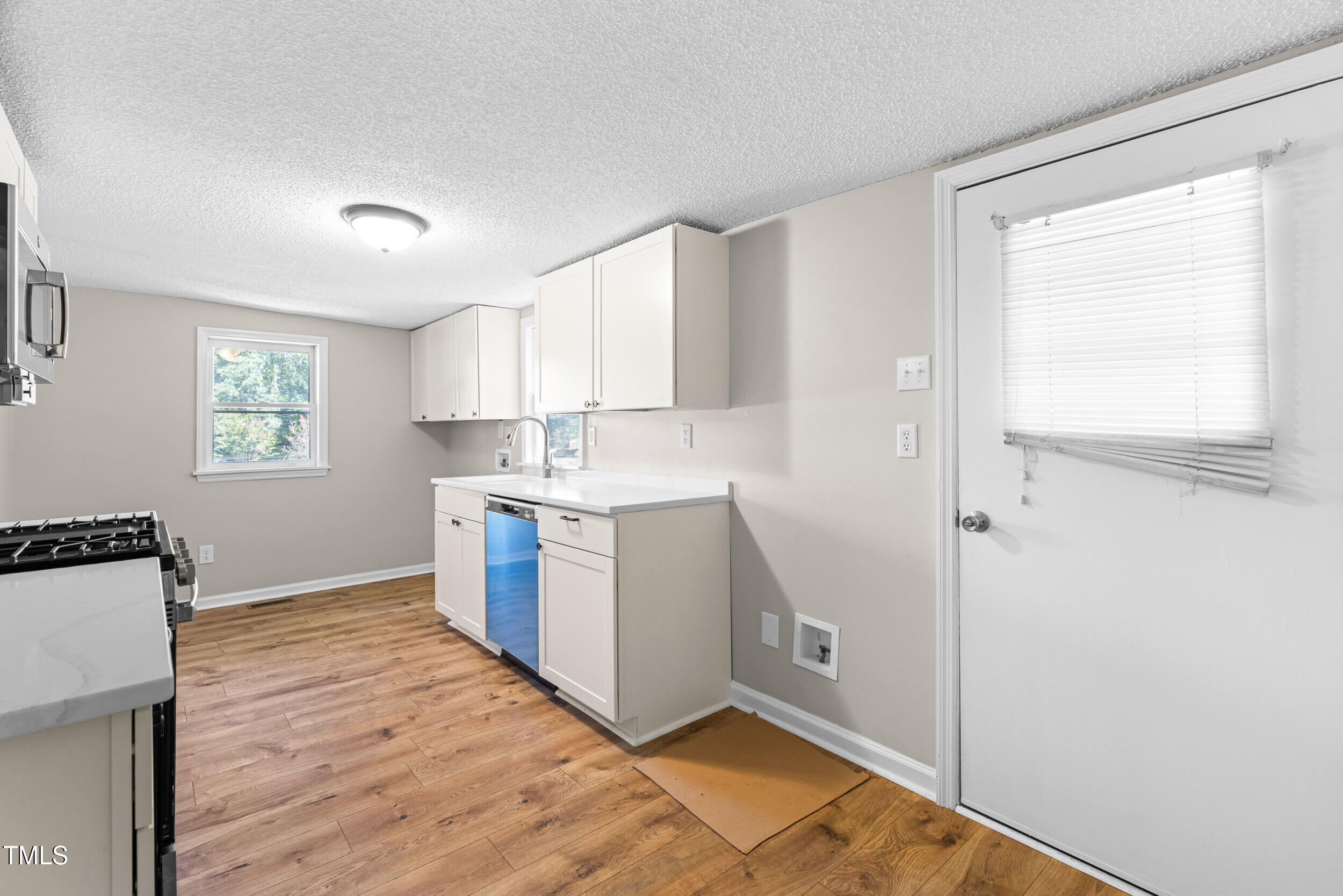 612 North 4th Street Smithfield, NC 27577 - Photo 13 of 22 a kitchen with a refrigerator and window