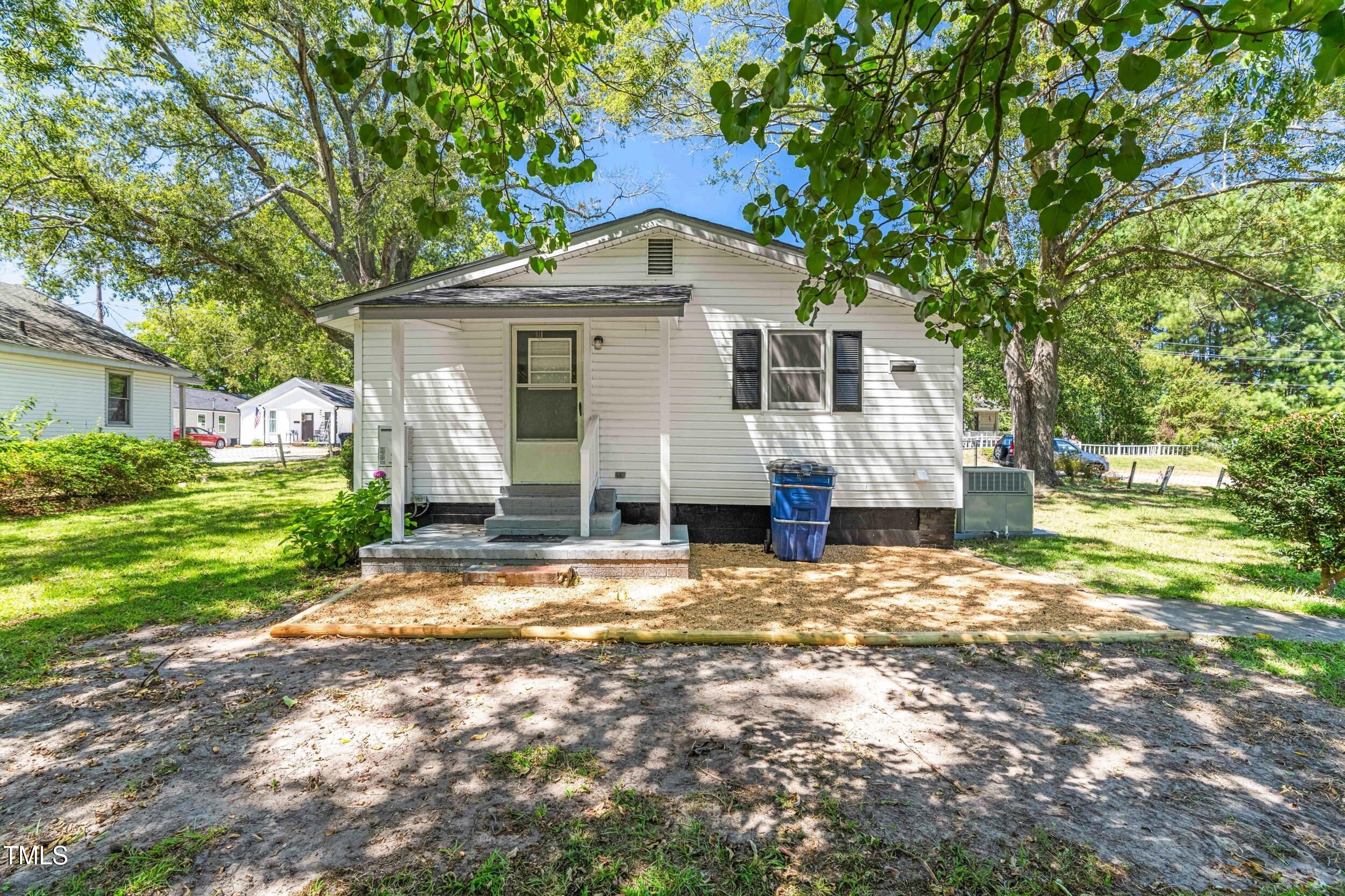 612 North 4th Street Smithfield, NC 27577 - Photo 21 of 22 a front view of a house with a yard and garage