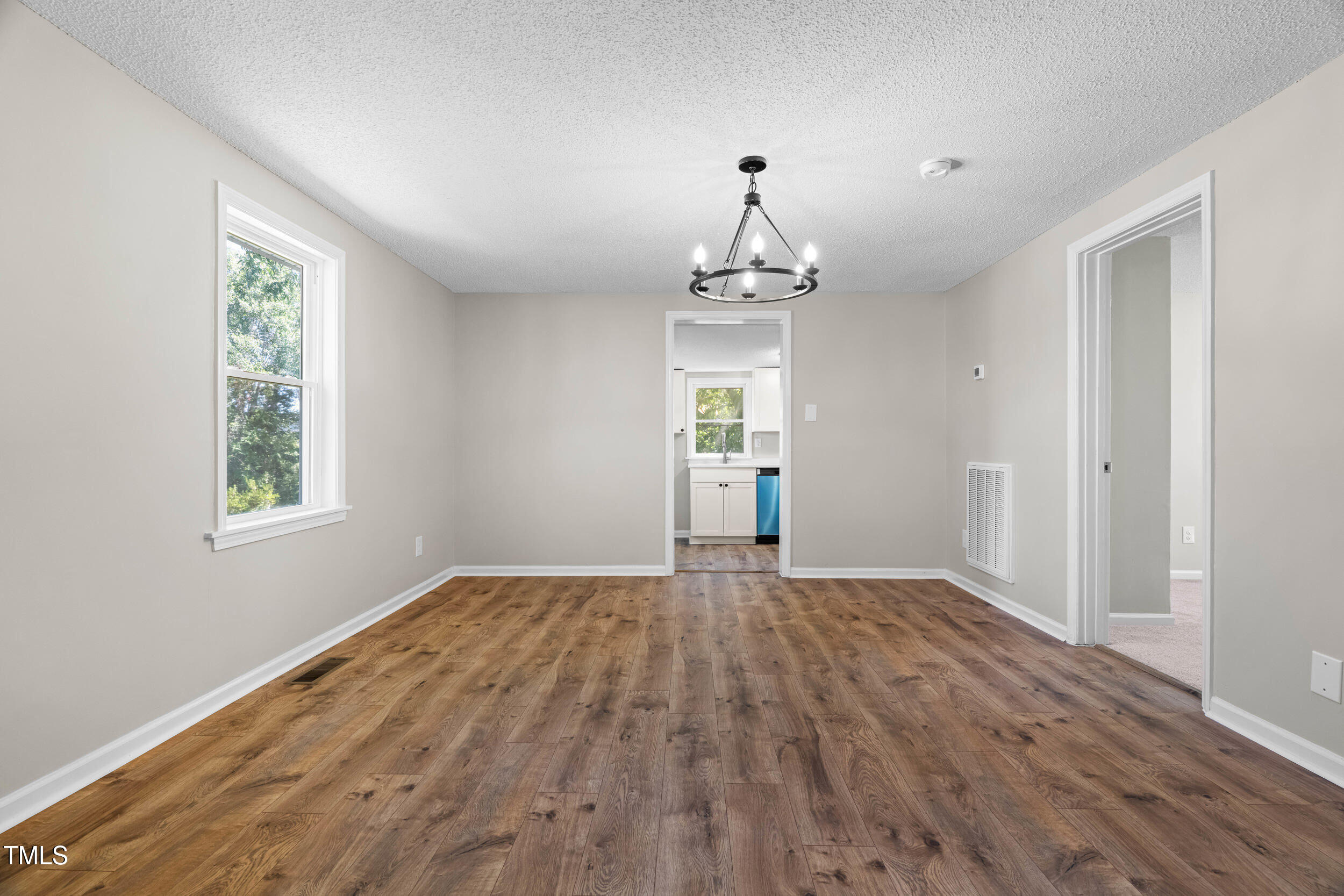 612 North 4th Street Smithfield, NC 27577 - Photo 6 of 22 a view of empty room with window and hardwood floor