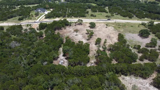 an aerial view of a houses with a yard