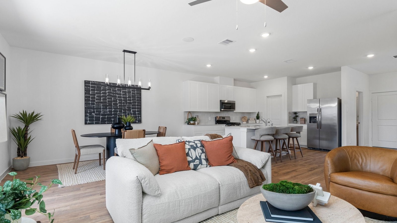 3531 Blue Mockingbird Street Katy, TX 77494 - Photo 12 of 41 a living room with furniture kitchen view and a potted plant
