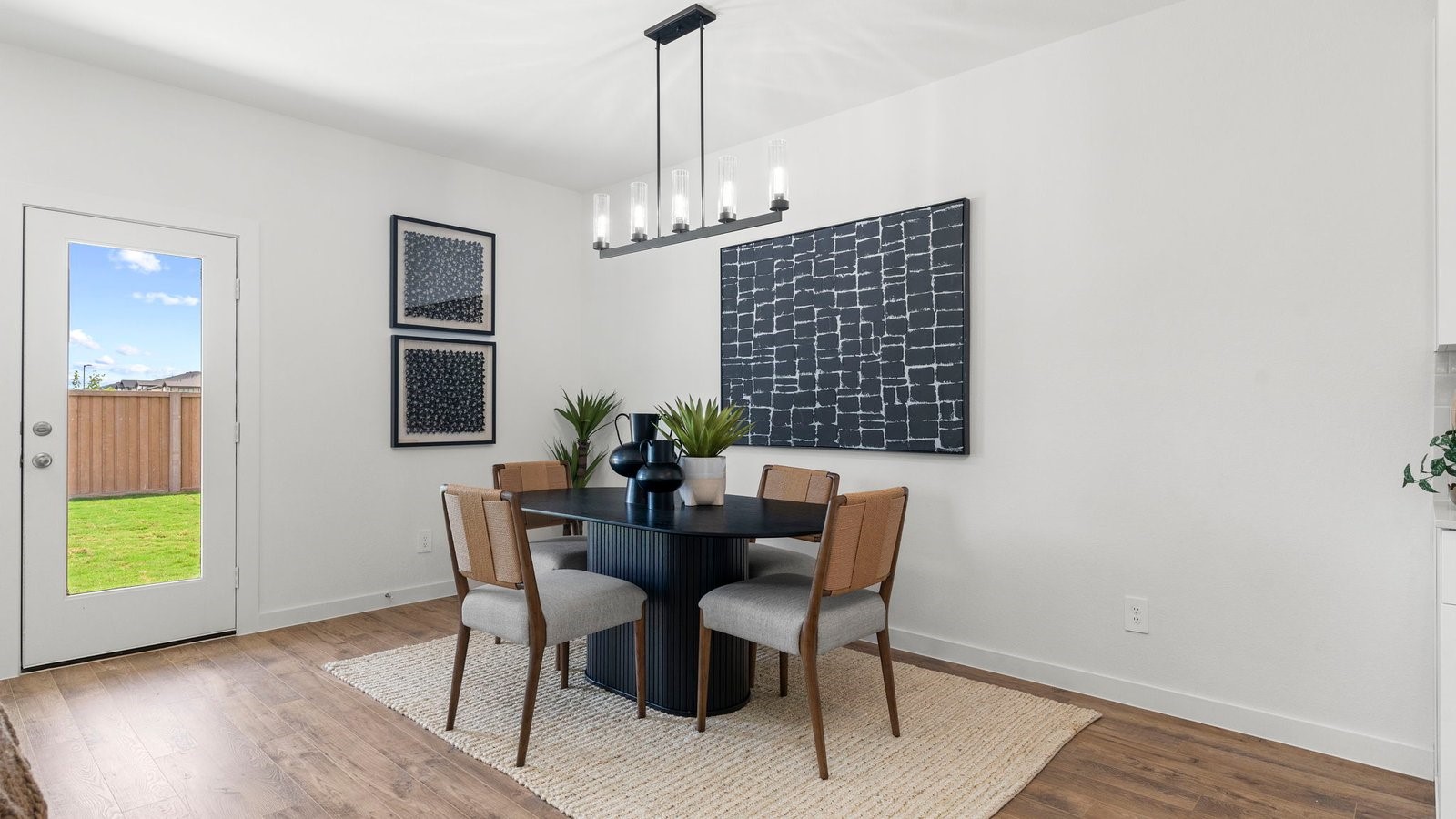 3531 Blue Mockingbird Street Katy, TX 77494 - Photo 13 of 41 a dining room with furniture a chandelier and wooden floor