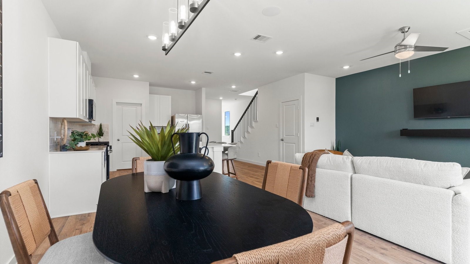 3531 Blue Mockingbird Street Katy, TX 77494 - Photo 15 of 41 a living room with furniture a flat screen tv and kitchen view