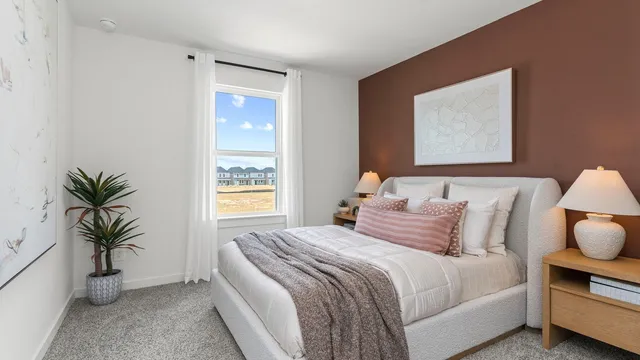 a bedroom with bed and a potted plant