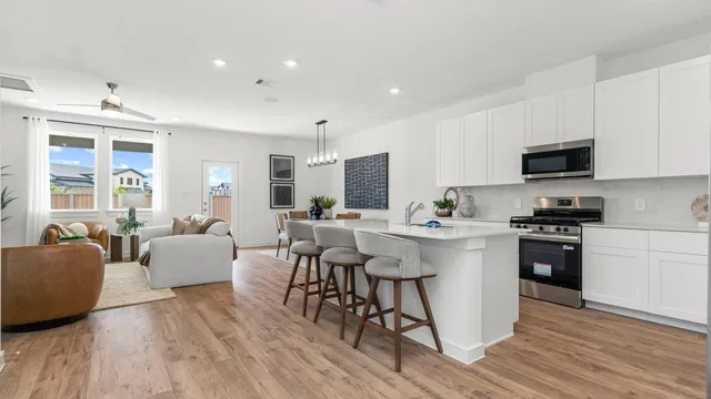 a kitchen with a sink a counter top space and stainless steel appliances