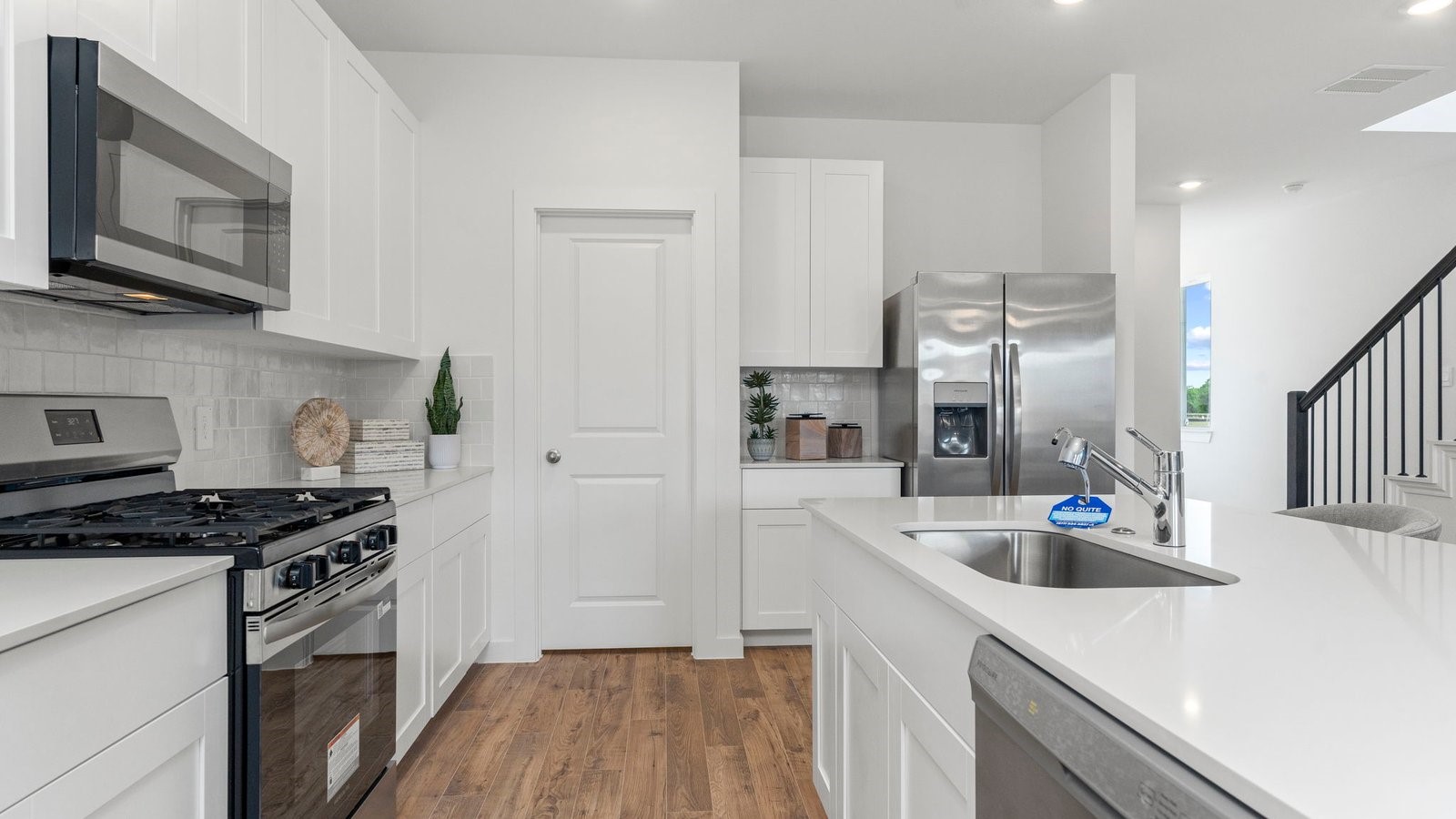 3531 Blue Mockingbird Street Katy, TX 77494 - Photo 8 of 41 a kitchen with stainless steel appliances a sink a stove a microwave a refrigerator and cabinets