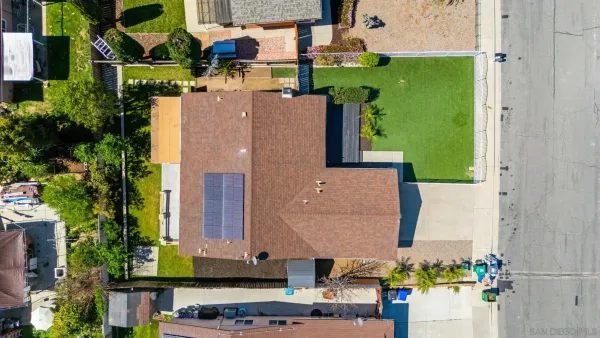 an aerial view of a house with a yard