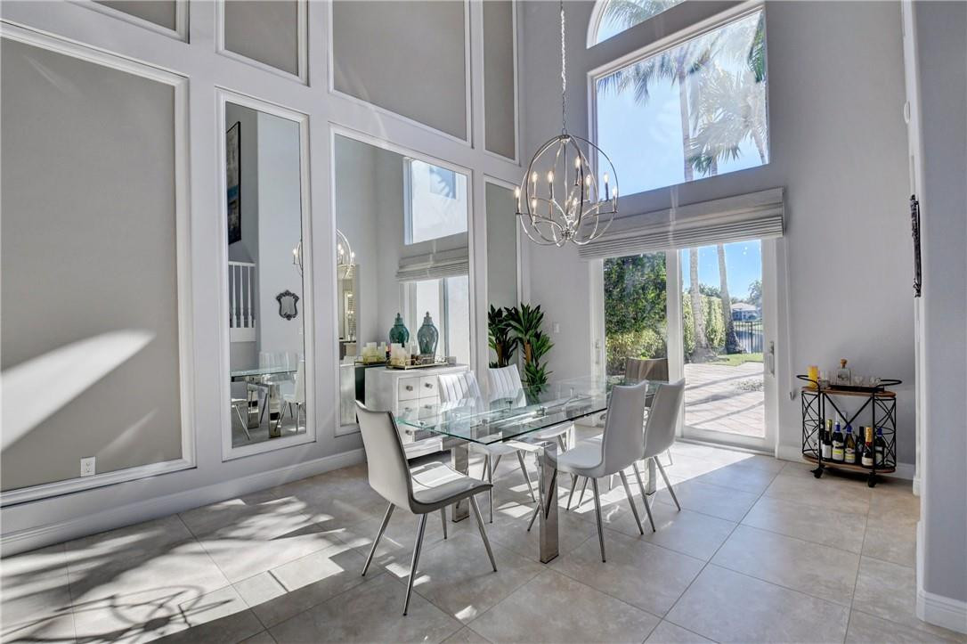 11750 Bayfield Drive Boca Raton, FL 33498 - Photo 20 of 70 a view of a dining room with furniture and chandelier