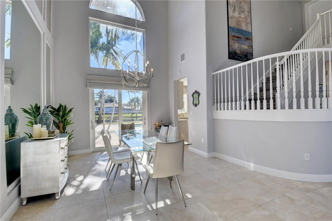 11750 Bayfield Drive Boca Raton, FL 33498 - Photo 22 of 70 a view of a dining room with furniture and a potted plant