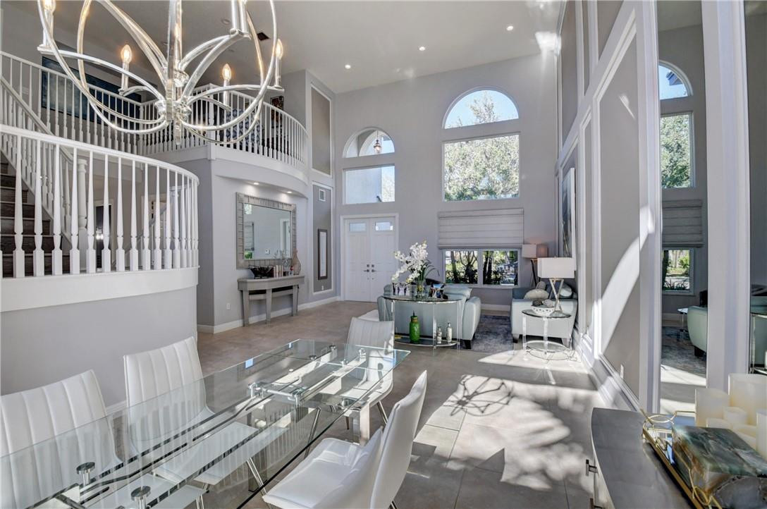 11750 Bayfield Drive Boca Raton, FL 33498 - Photo 23 of 70 a view of a livingroom with furniture a rug wooden floor and a chandelier