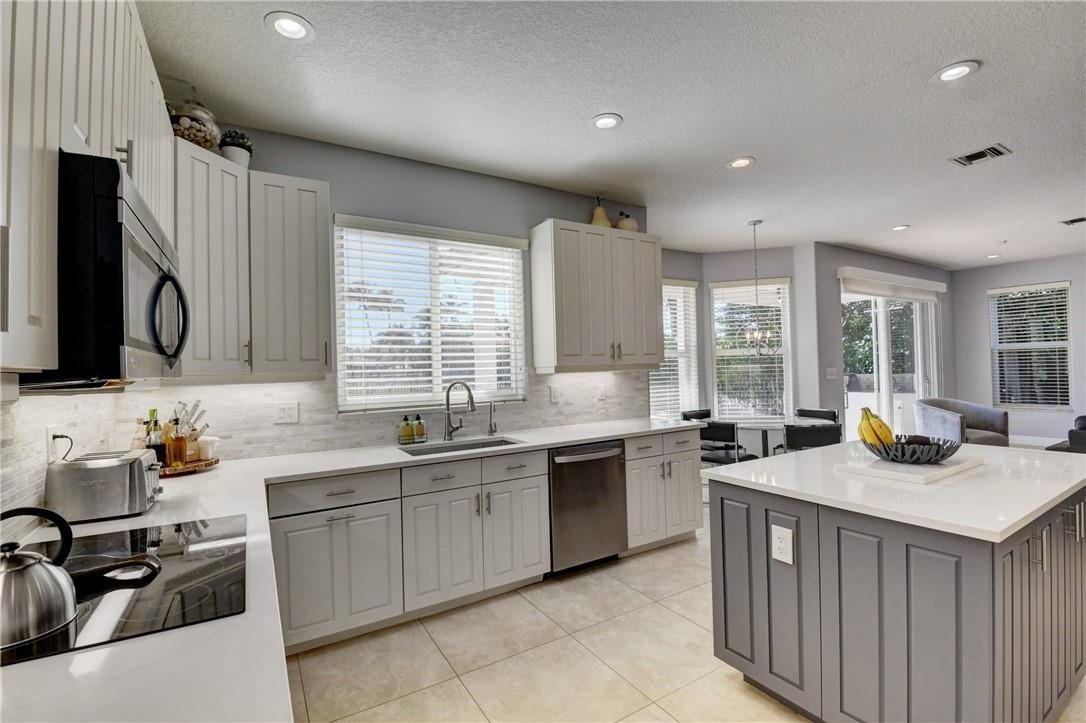 11750 Bayfield Drive Boca Raton, FL 33498 - Photo 26 of 70 a kitchen with lots of counter space and a sink