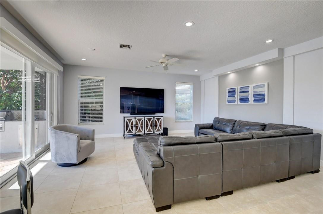 11750 Bayfield Drive Boca Raton, FL 33498 - Photo 32 of 70 a living room with furniture and a flat screen tv