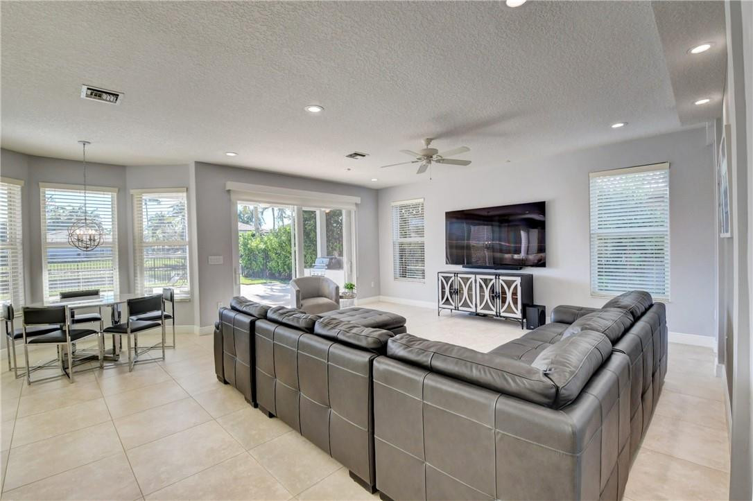 11750 Bayfield Drive Boca Raton, FL 33498 - Photo 33 of 70 a living room with furniture and a flat screen tv