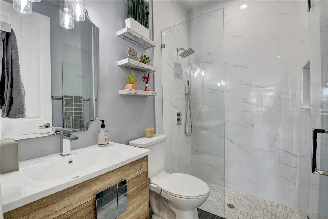 11750 Bayfield Drive Boca Raton, FL 33498 - Photo 36 of 70 a bathroom with a sink a toilet and shower