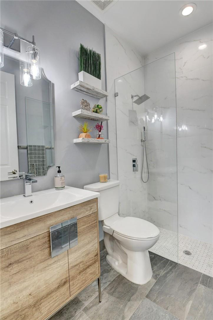 11750 Bayfield Drive Boca Raton, FL 33498 - Photo 37 of 70 a bathroom with a sink toilet and shower