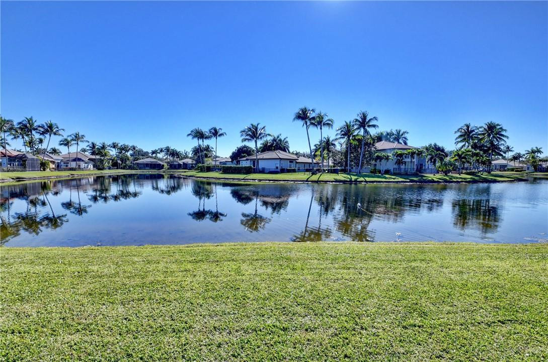 11750 Bayfield Drive Boca Raton, FL 33498 - Photo 42 of 70 a swimming pool with outdoor seating and lake view