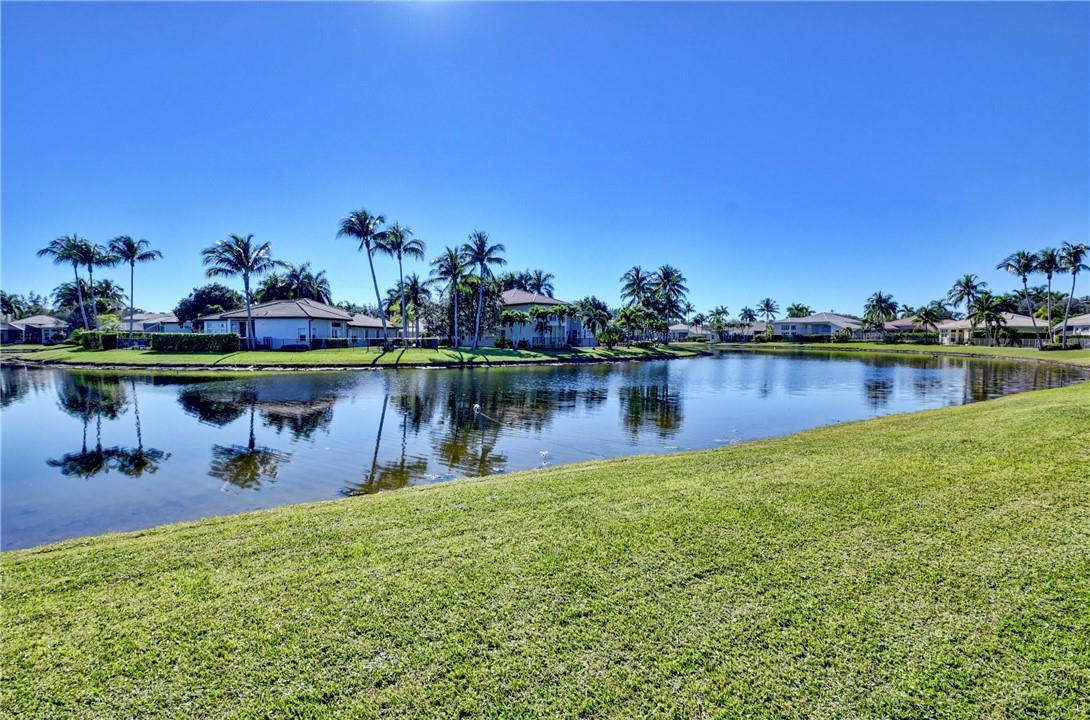 11750 Bayfield Drive Boca Raton, FL 33498 - Photo 43 of 70 a view of a lake with a table and chairs