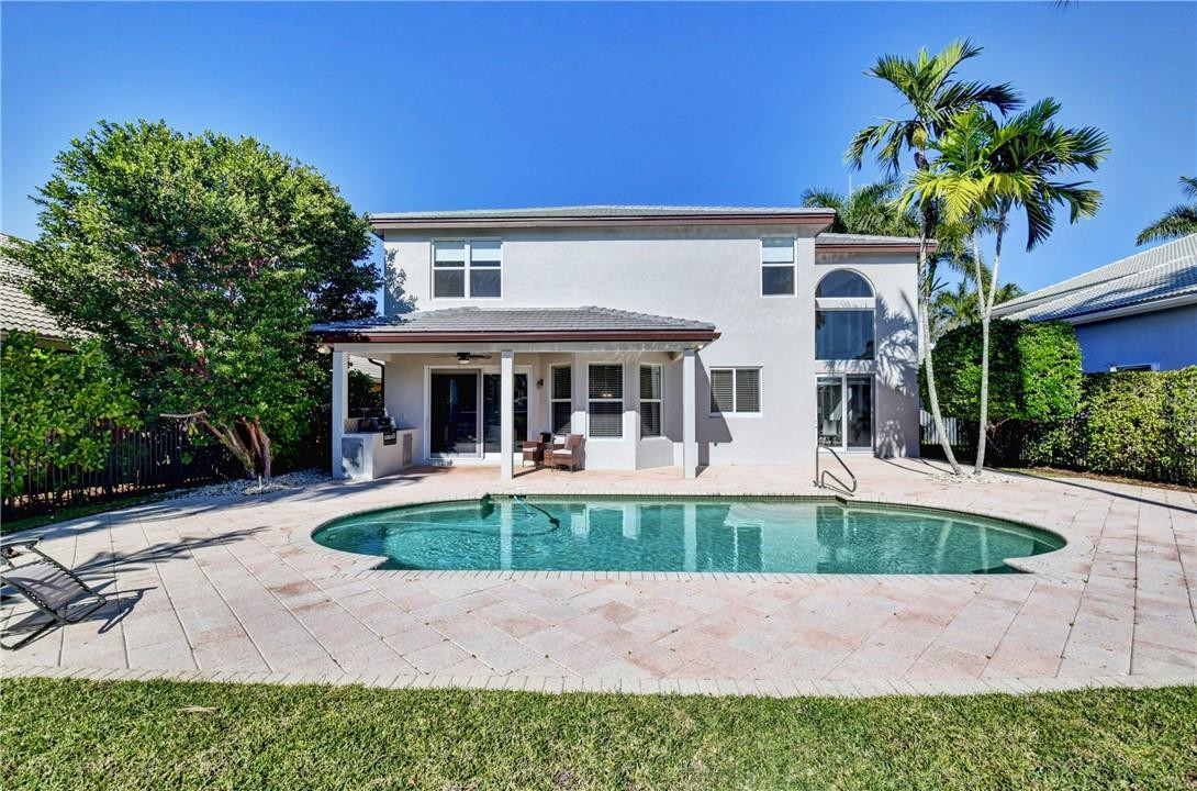 11750 Bayfield Drive Boca Raton, FL 33498 - Photo 44 of 70 a front view of house with yard swimming pool and seating