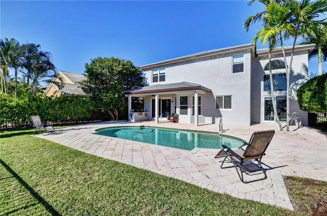 11750 Bayfield Drive Boca Raton, FL 33498 - Photo 45 of 70 a view of house with a backyard and a patio