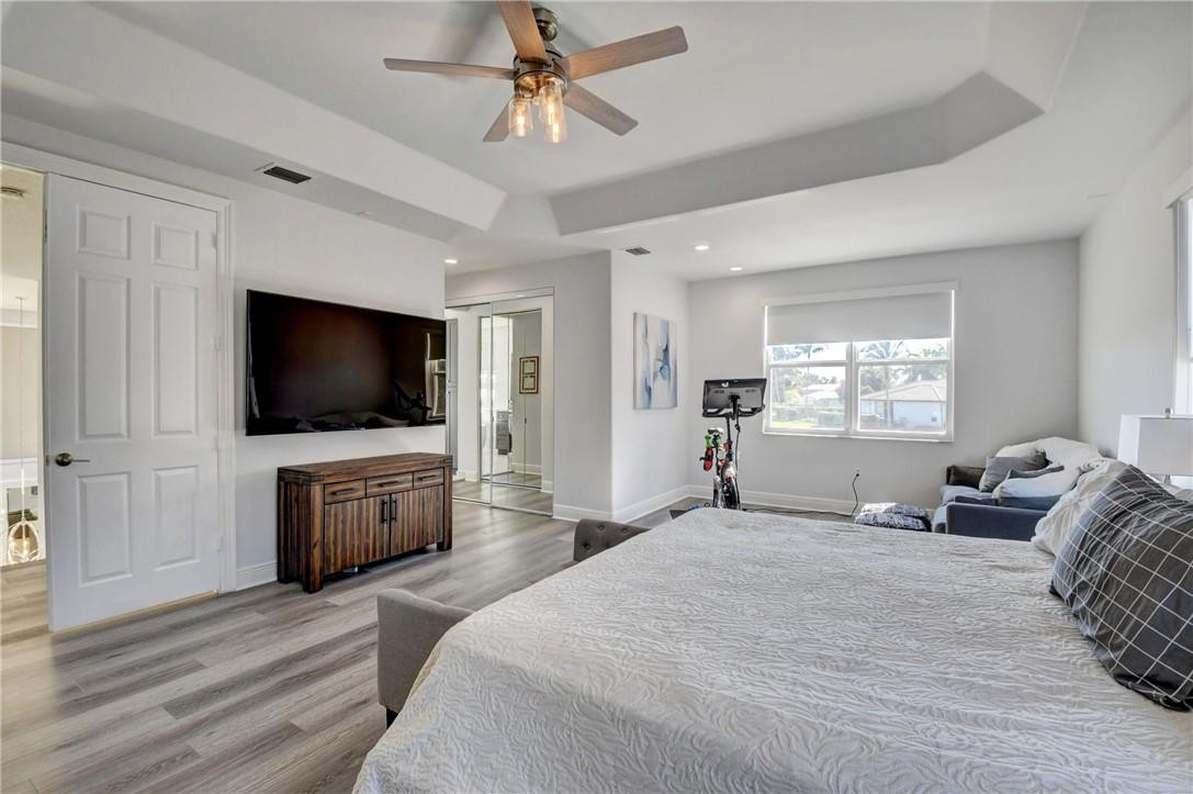 11750 Bayfield Drive Boca Raton, FL 33498 - Photo 53 of 70 a bedroom with a flat screen television and a bed
