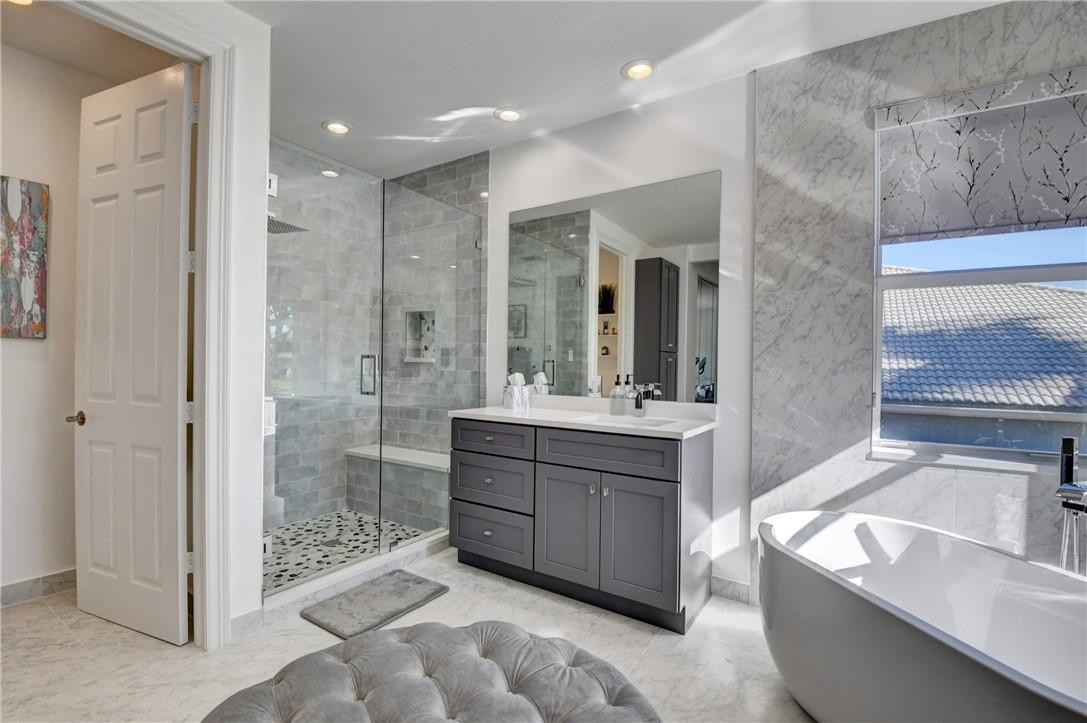 11750 Bayfield Drive Boca Raton, FL 33498 - Photo 57 of 70 a bathroom with a granite countertop sink mirror and shower