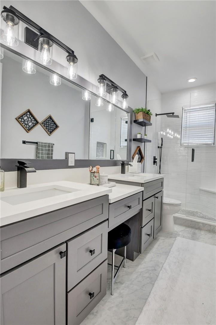 11750 Bayfield Drive Boca Raton, FL 33498 - Photo 61 of 70 a spacious bathroom with a granite countertop sink a toilet a mirror and bathtub